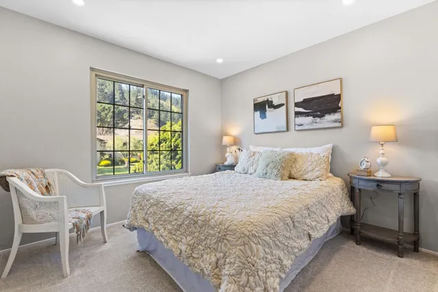 a bedroom with a bed and a potted plant