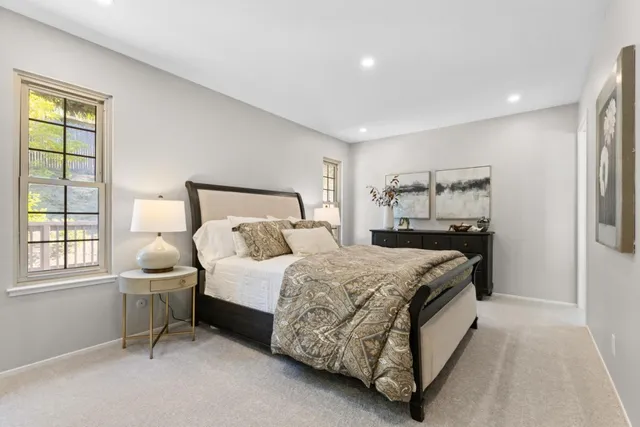 a bedroom with a bed and large window