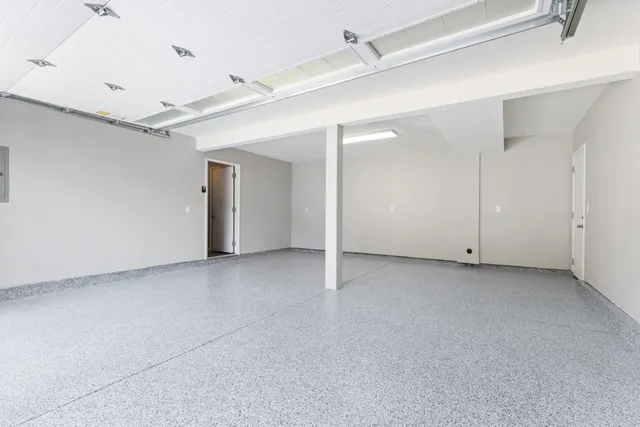 an aerial view of residential houses with outdoor space and trees