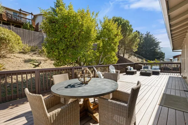 a view of a chairs and table on the roof deck