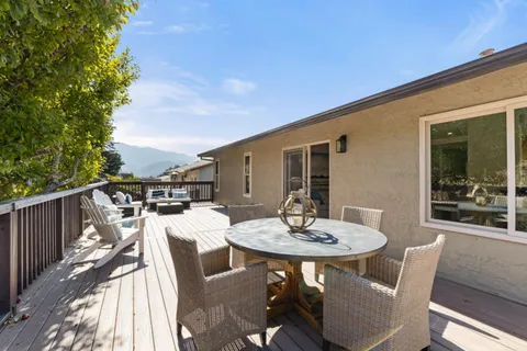 a view of a patio with a table and chairs