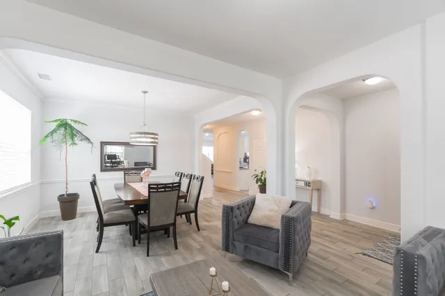 a view of a dining room with furniture and wooden floor