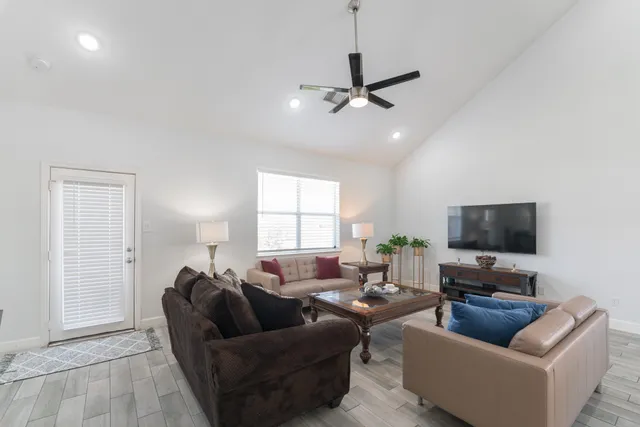 a living room with furniture and a flat screen tv