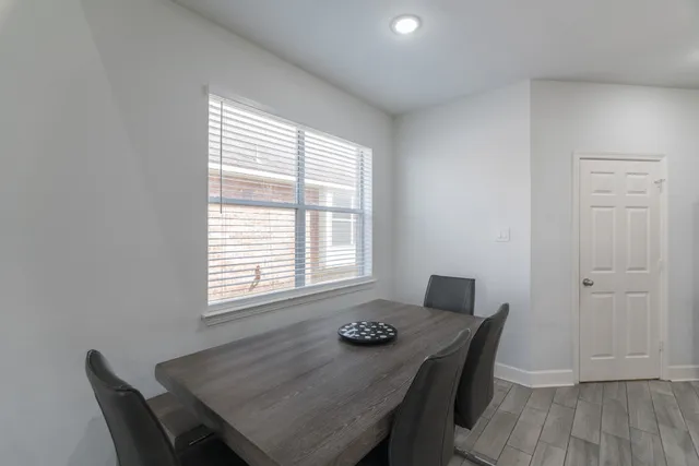 a view of a dining room with a table and chairs