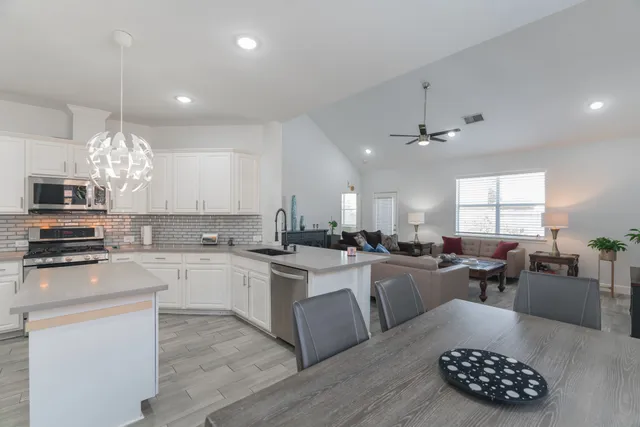 a kitchen with counter top space appliances a sink and cabinets