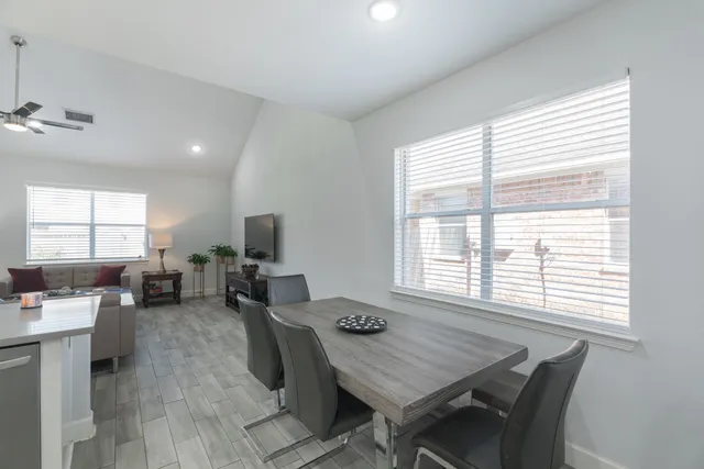 a dining room with wooden floor and a window