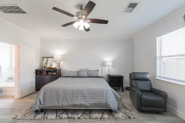 a bedroom with a bed couch and a window