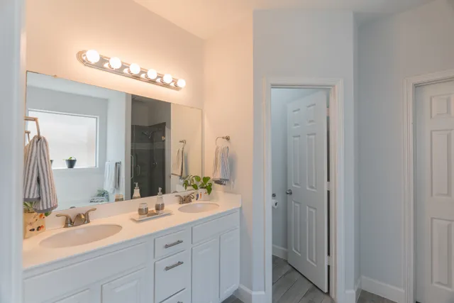a bathroom with a double vanity sink and a mirror