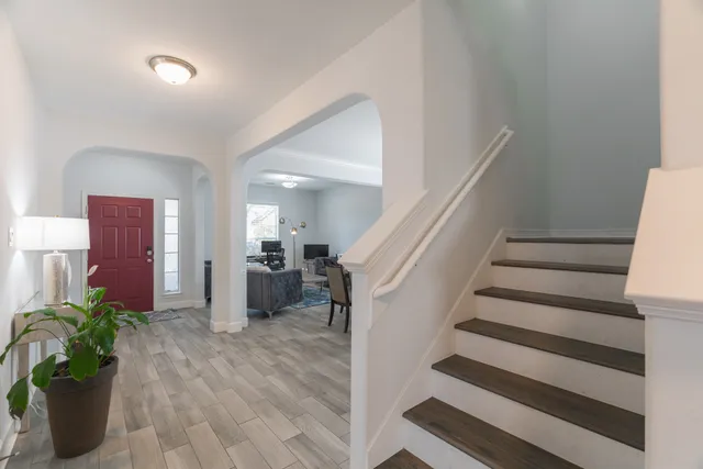 a view of entryway and hall with wooden floor