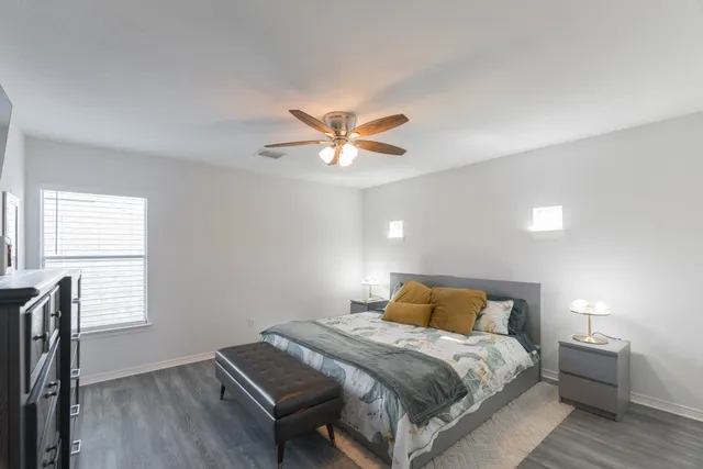 a bedroom with a bed and window