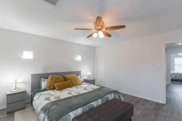 a bedroom with a bed and a ceiling fan