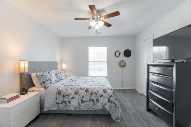a bedroom with a bed and a chandelier