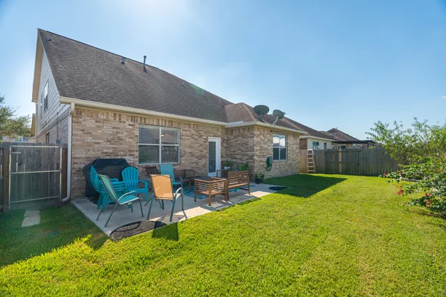 a front view of house with outdoor seating and yard