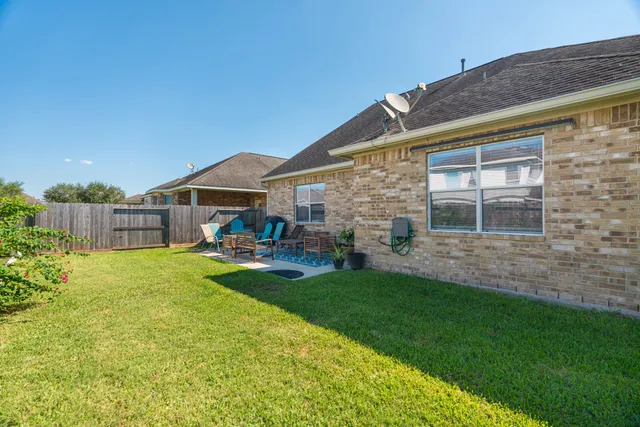 a front view of house with yard and outdoor seating