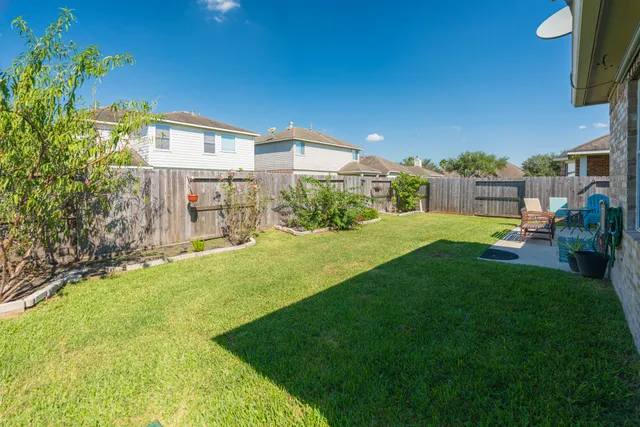 a view of a backyard with plants and a patio