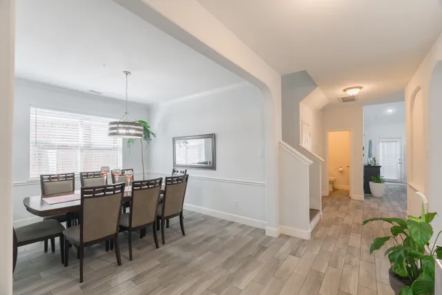 a view of a dining room with furniture and wooden floor