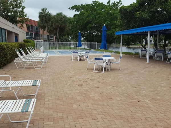 a view of a patio with a dining table and chairs with a fire pit