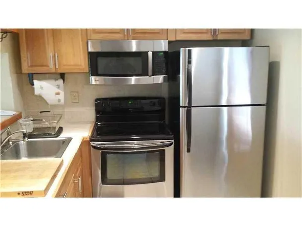 a kitchen with a refrigerator and a sink