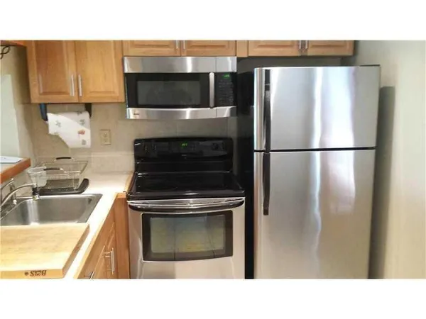 a kitchen with a refrigerator and a sink