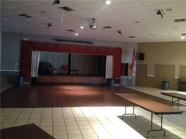 a lobby with furniture and a rug