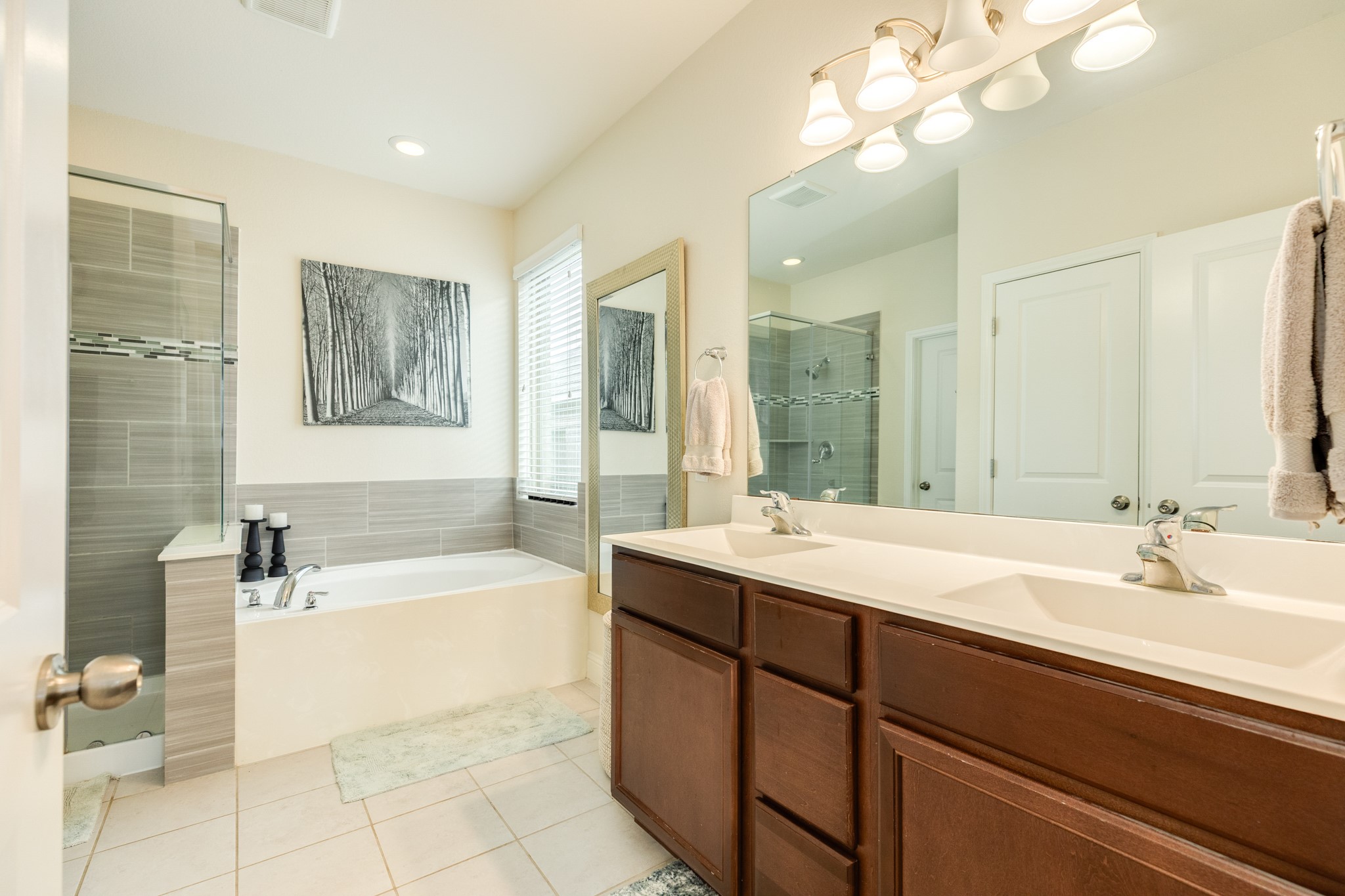 3519 Bay Drive Rosharon, TX 77583 - Photo 21 of 49 Primary bathroom featuring dual vanities, a spacious glass-enclosed walk-in shower, a deep soaking tub, and a large walk-in closet.