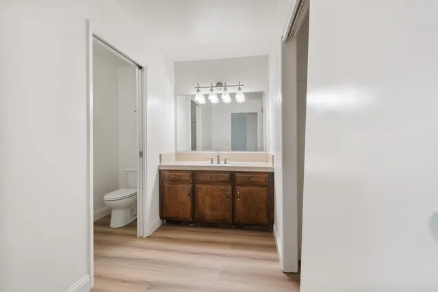 a bathroom with a toilet a sink and mirror