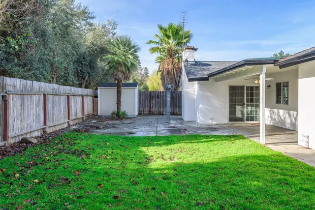 a view of a house with a yard and plants