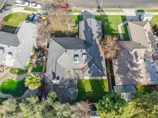 an aerial view of a house with a swimming pool
