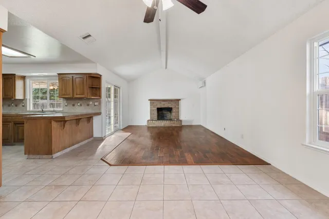 a view of kitchen with granite countertop stove top oven and cabinets