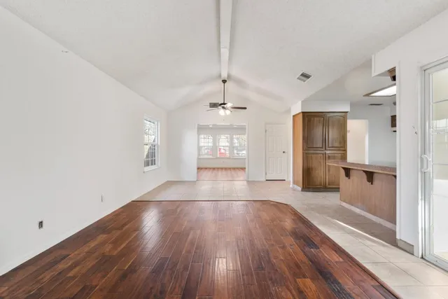 a view of a room with wooden floor and window
