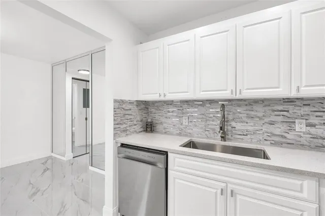 a kitchen with stainless steel appliances granite countertop a sink and cabinets