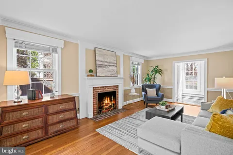 a view of room with wooden floor lounge chair and windows