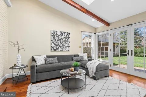 a vase of flowers sitting on a table with window