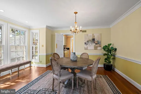 a view of a backyard with table and chairs and a large tree