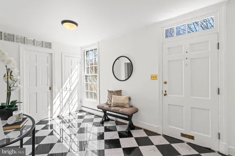 a view of a hallway with wooden floor and a dining room