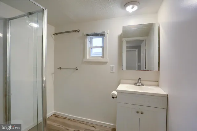 a bathroom with a sink mirror and vanity