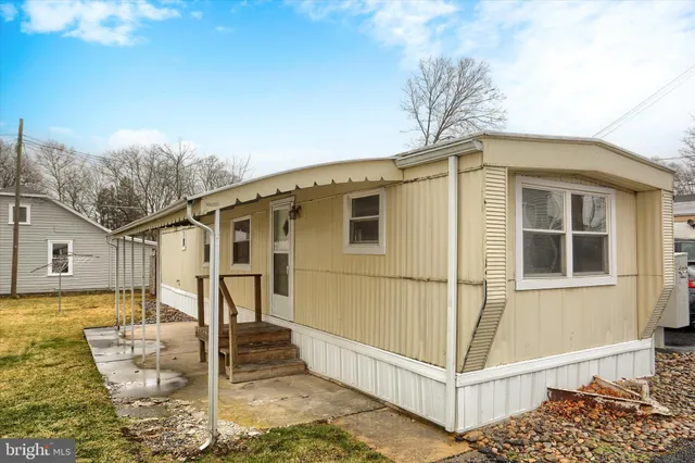 a view of a house with a wooden fence