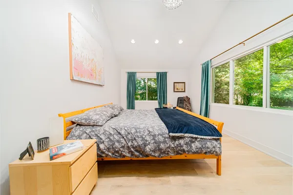 a bedroom with a bed and a chandelier