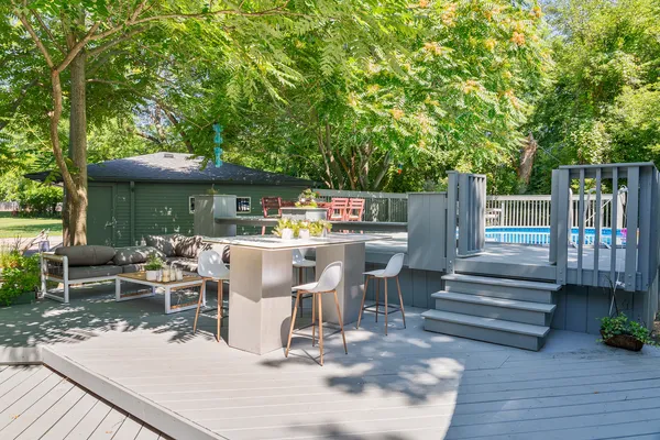 a view of a house with backyard porch and sitting area
