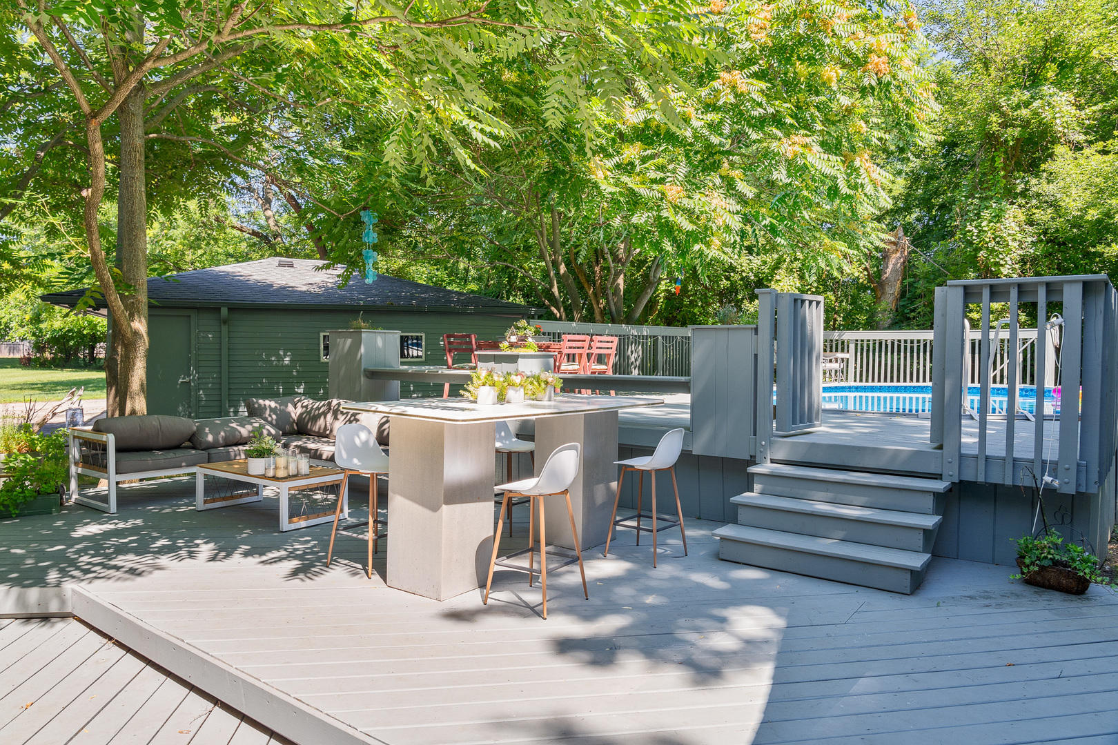 20665 Weiland Road Lincolnshire, IL 60069 - Photo 25 of 32 a view of a patio with table and chairs potted plants and large tree