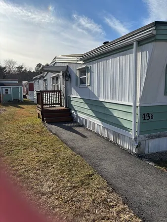 a view of a house with a yard next to a road