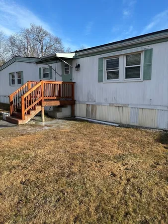 a view of a house with backyard and porch