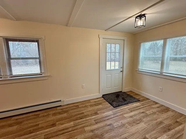 a view of a backyard with plants and chairs