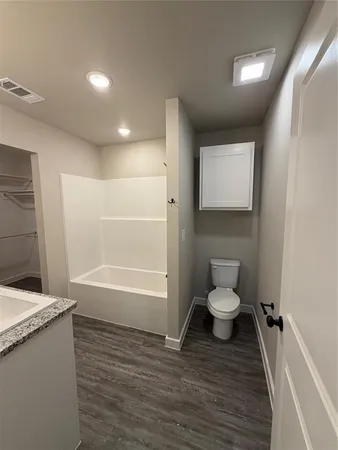 a bathroom with a toilet a sink and bathtub