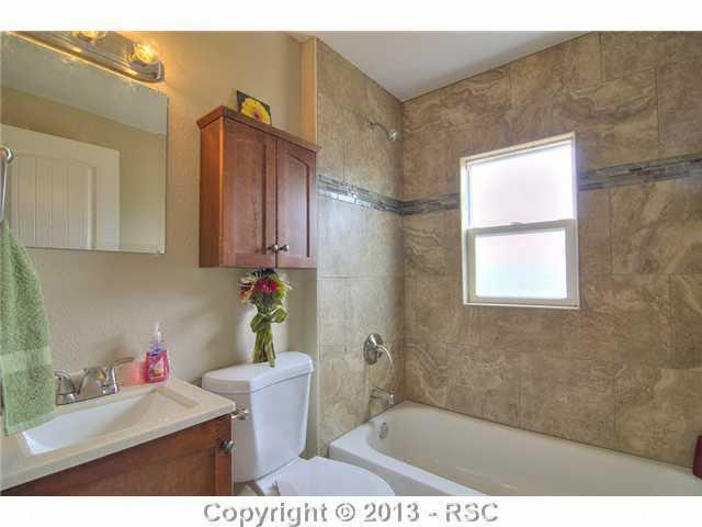10865 Falling Star Road Fountain, CO 80817 - Photo 16 of 23 Spectacular custom tile work throughout bathroom.