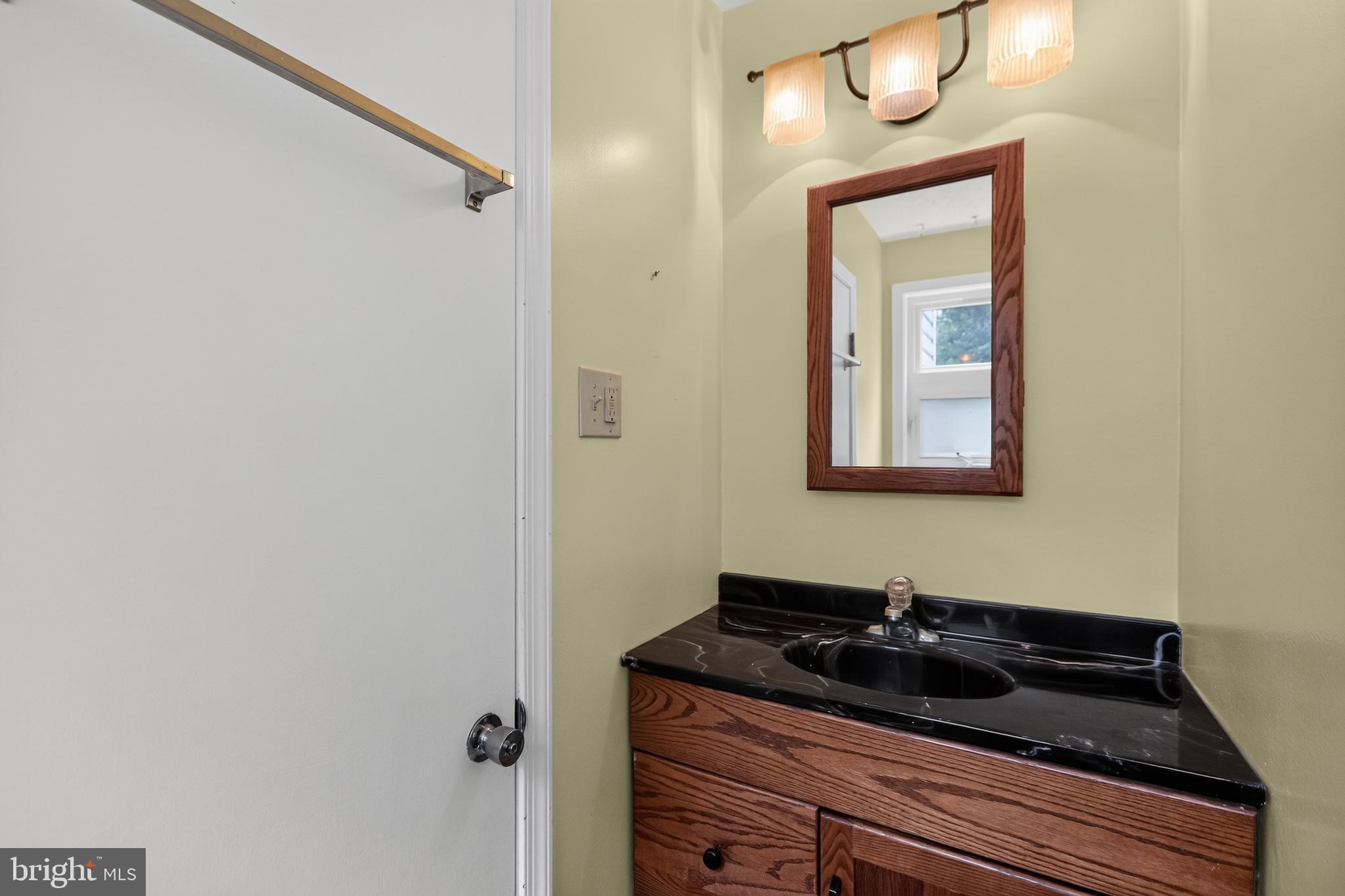 1408 Ponds Edge Road West Chester, PA 19382 - Photo 33 of 53 a bathroom with a granite countertop sink and a mirror