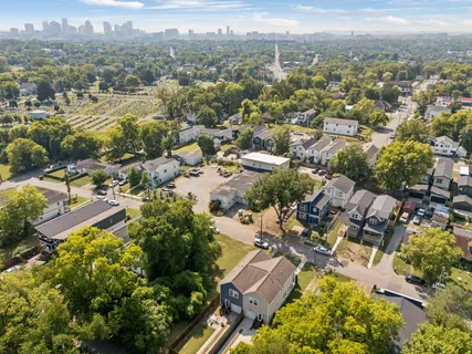 an aerial view of residential house with green space