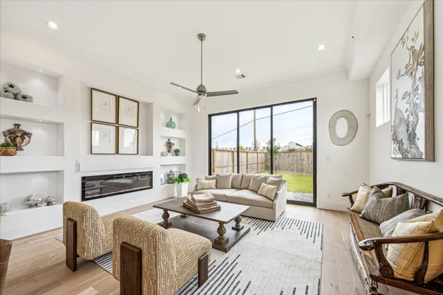 a living room with furniture fireplace and a large window