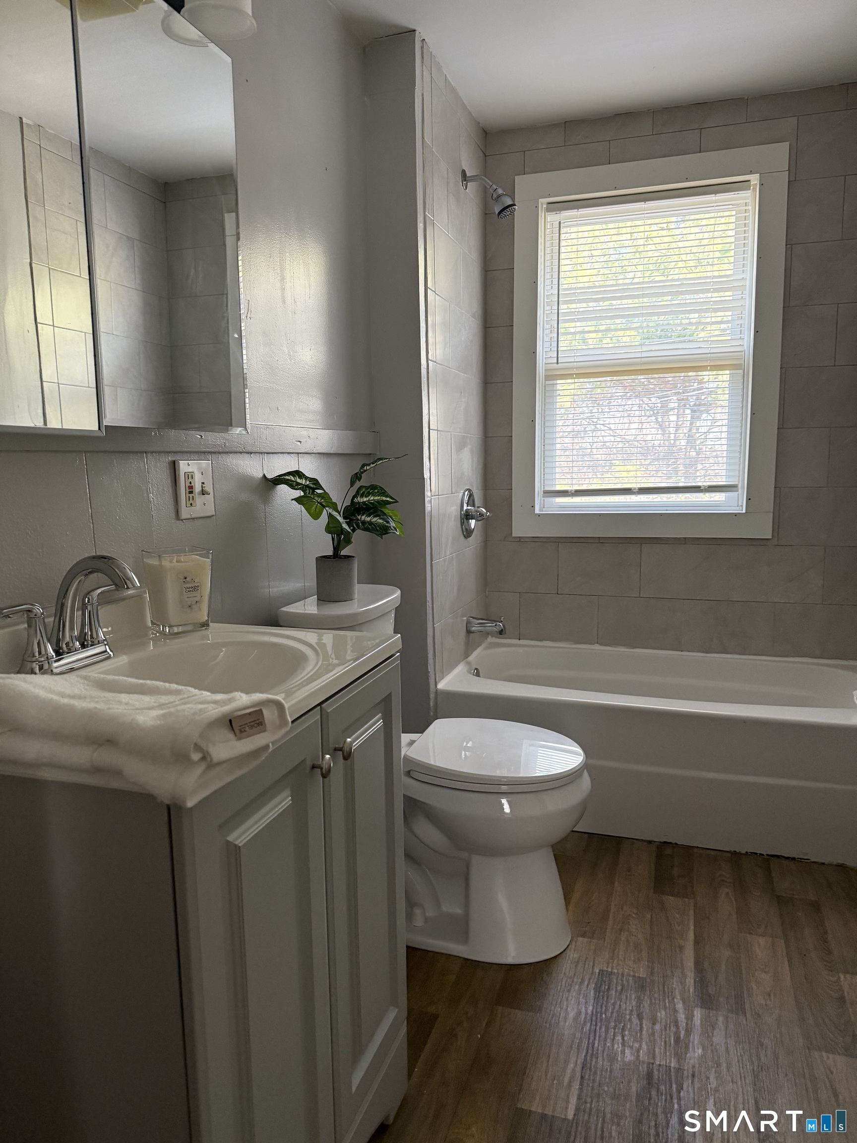 8 Rogers Place Manchester, CT 06040 - Photo 12 of 16 a bathroom with a granite countertop toilet a sink and a bathtub