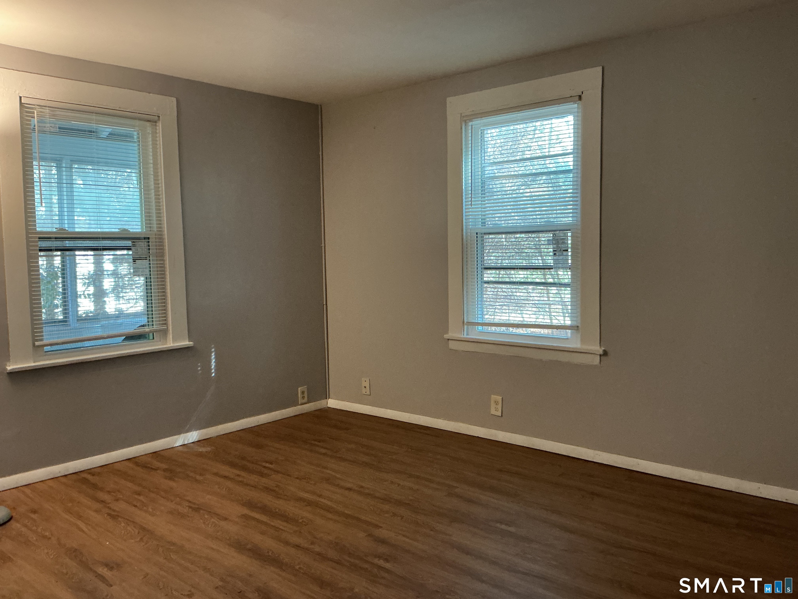 8 Rogers Place Manchester, CT 06040 - Photo 5 of 16 a view of an empty room with wooden floor and a window
